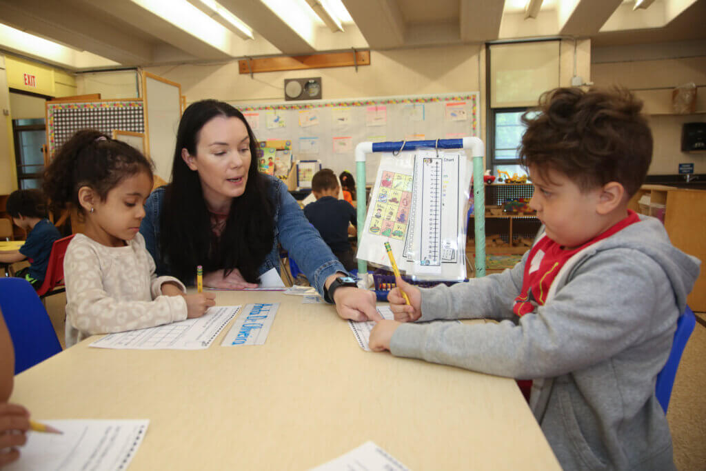 Young students and a teacher in a classroom at the Belmont Street Community School in 2023.