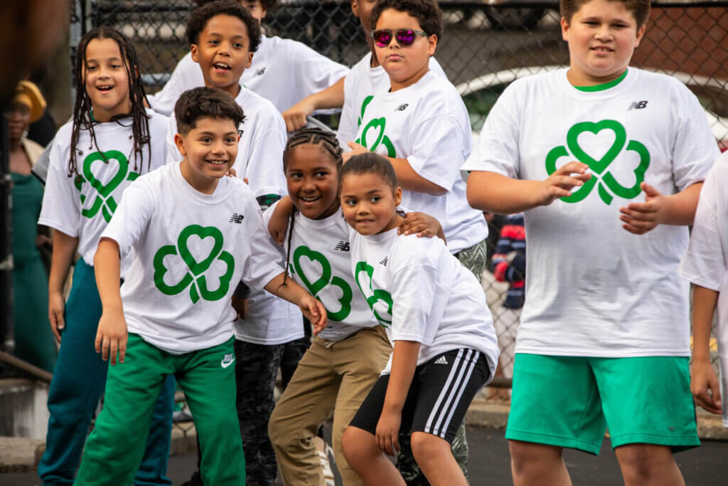 Students smile while wearing Celtics t-shirts