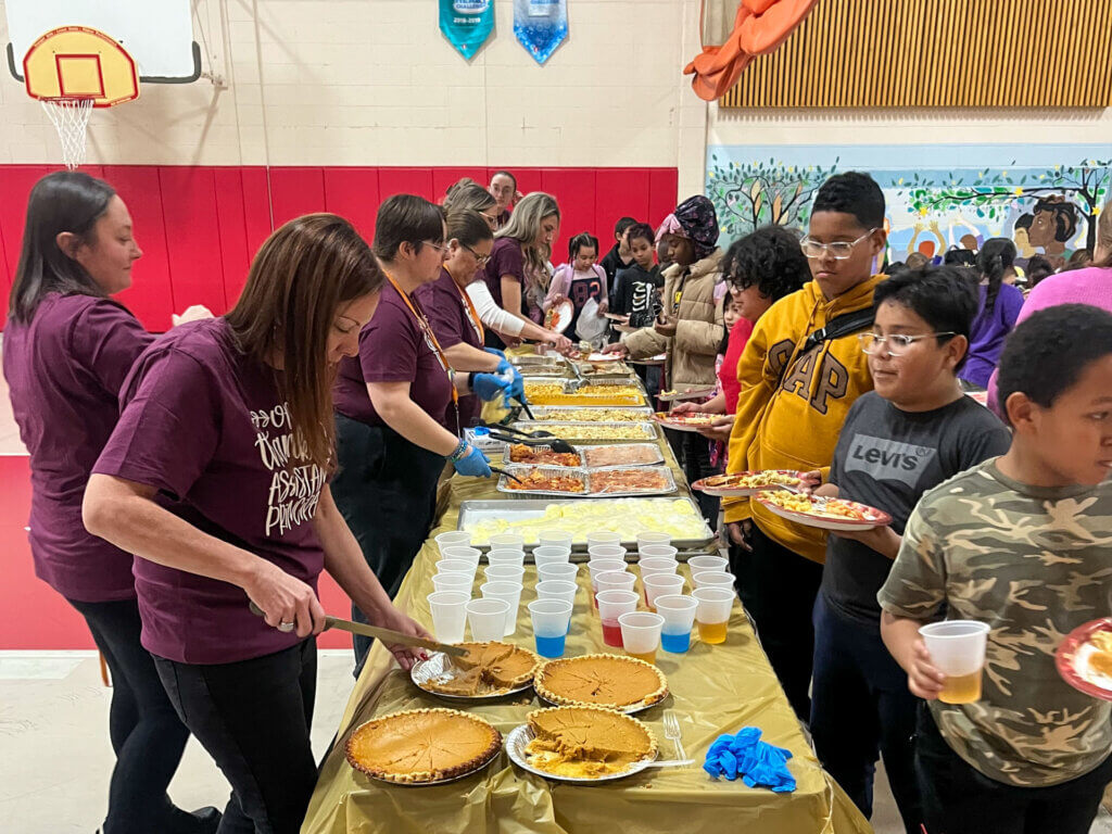 Canterbury Street staff serve students a Thanksgiving meal.