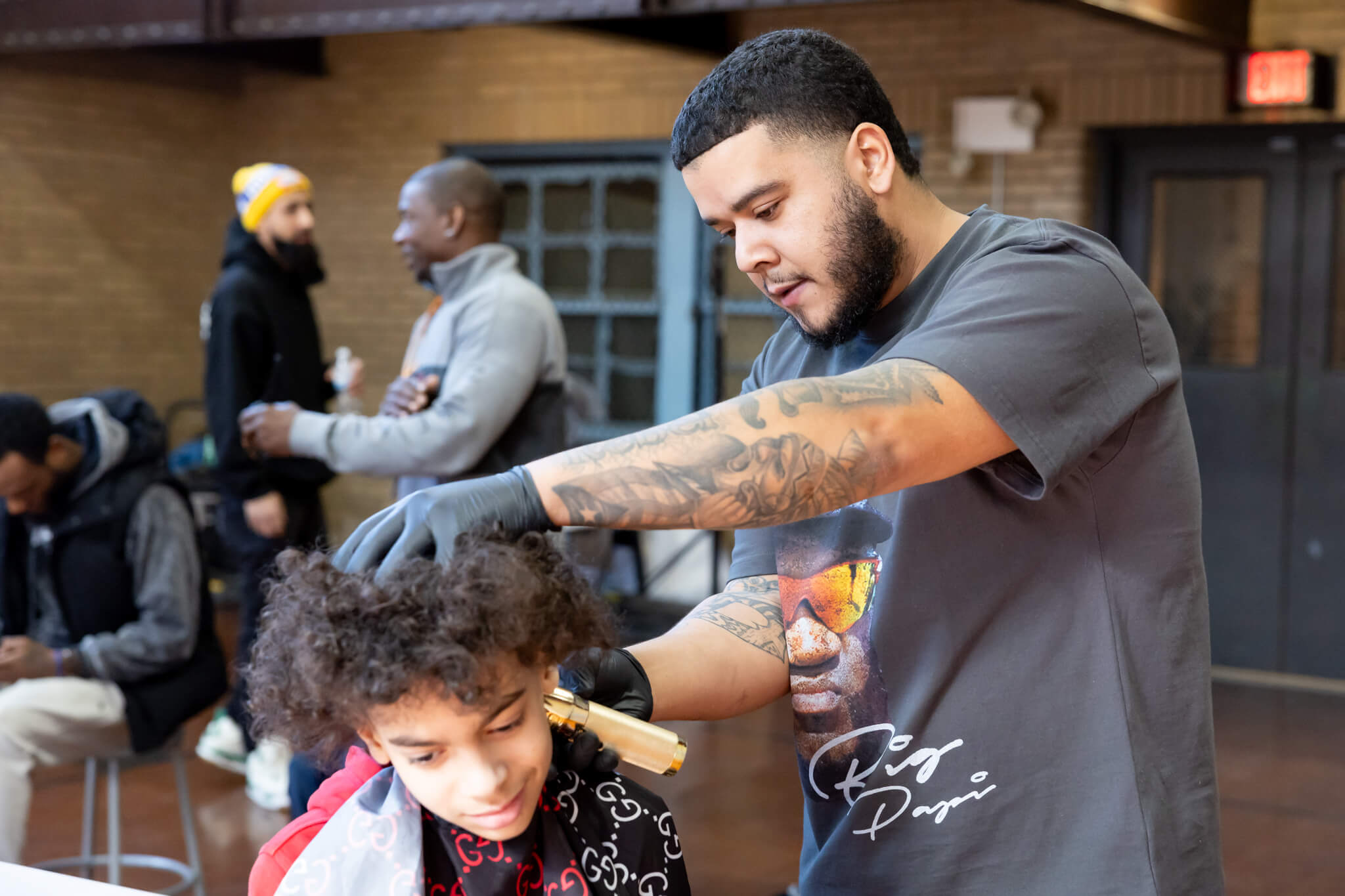 A barber cuts the hair of a student at Vernon Hilll School.